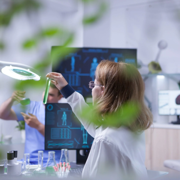 female-scientist-holding-looking-sample-liquid-test-tube-academic-scientist-1-scaled