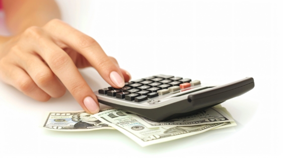 closeup-female-hands-with-bill-calculator