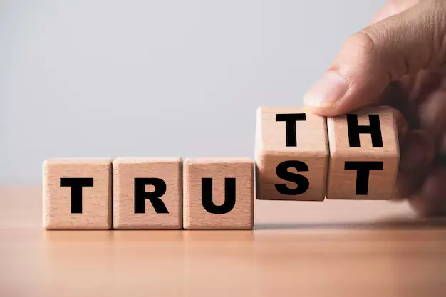 Wooden blocks spelling trust and truth, representing integrity