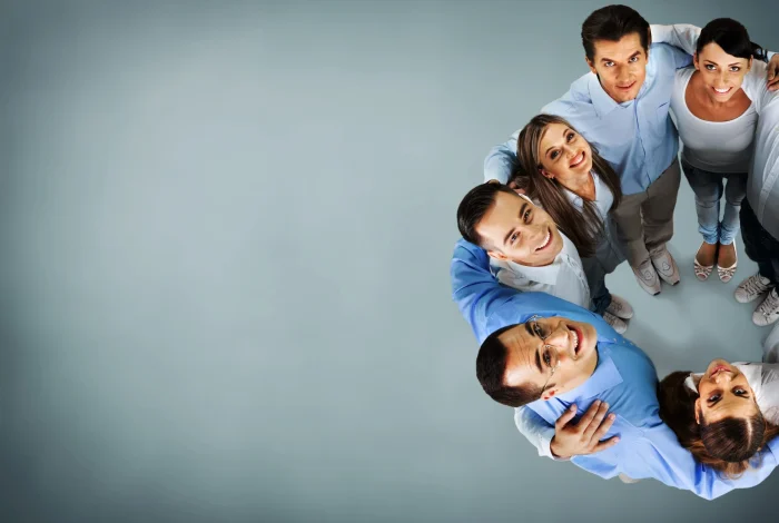 group-smiling-multi-ethnic-colleagues-standing-circle-scaled